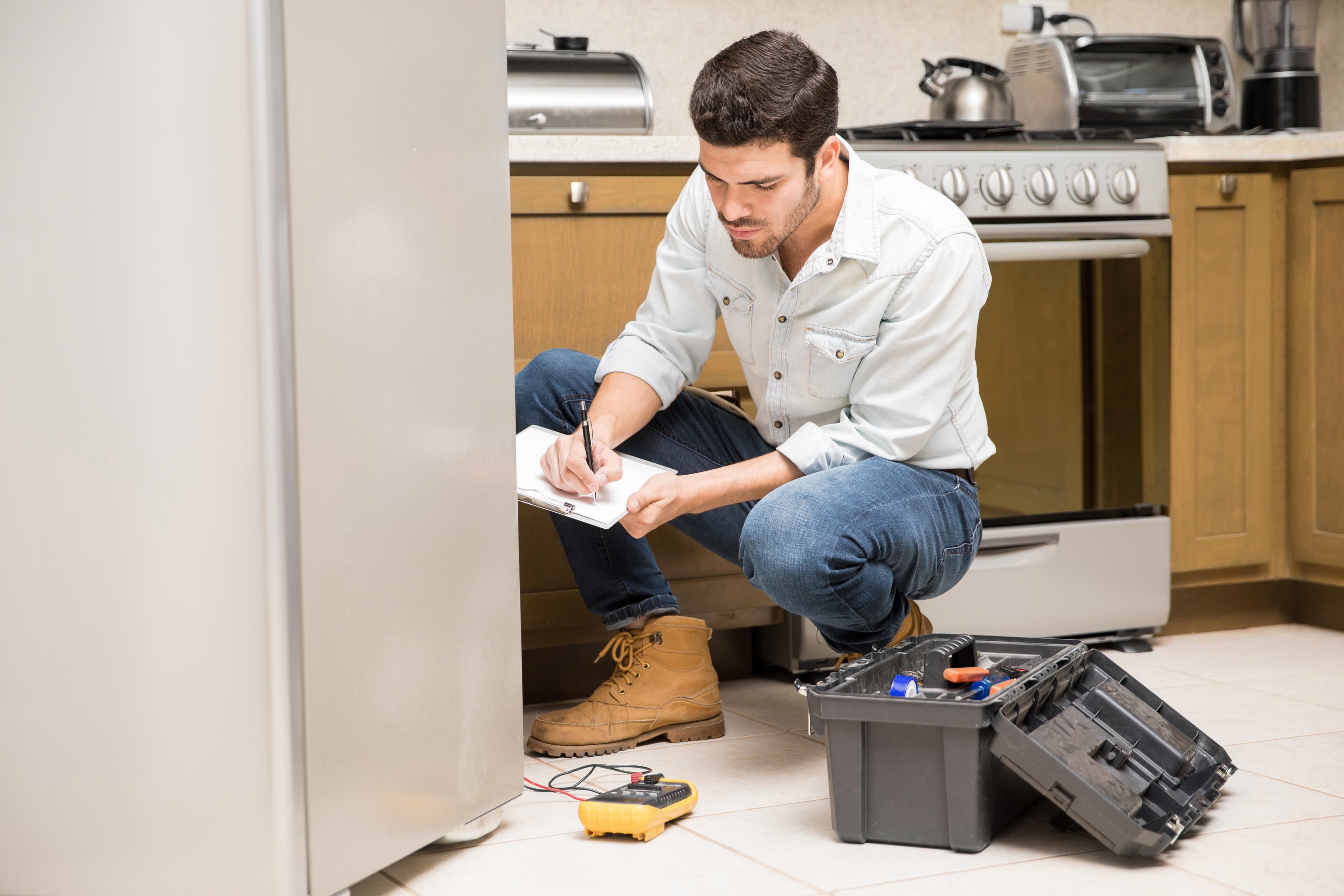 Appliance repair technician servicing a home appliance in Kashmir